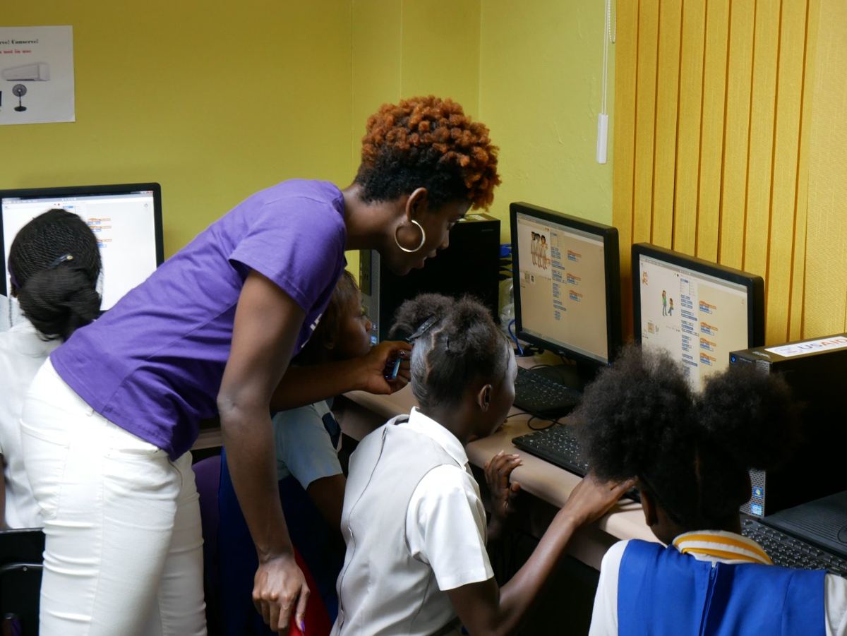 Students working together on coding projects in a school computer lab
