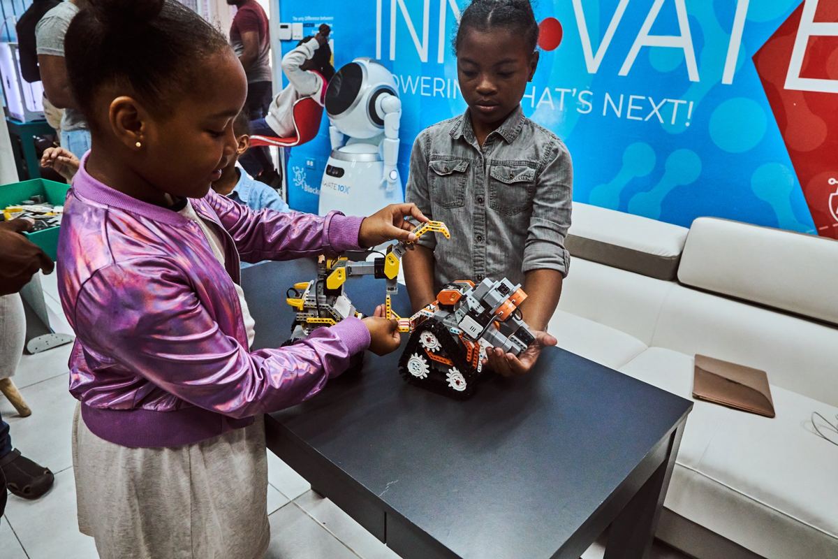 Young people building and programming robots at a YCDI robotics session